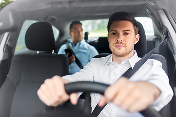 Image showing male driver driving car with passenger