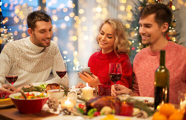 Image showing friends with cellphone celebrate christmas at home