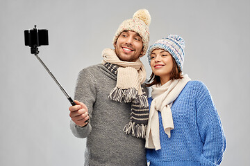 Image showing happy couple in winter clothes taking selfie