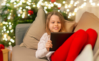 Image showing smiling girl with tablet pc at christmas home