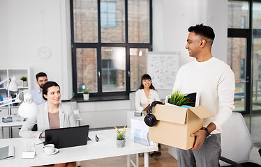 Image showing happy male office worker with personal stuff