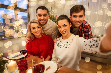 Image showing friends taking selfie at christmas dinner