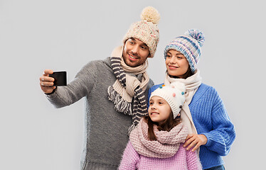 Image showing happy family taking selfie by smartphone