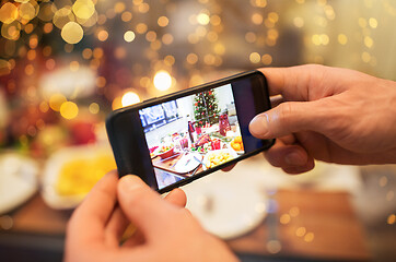 Image showing hands photographing food at christmas dinner