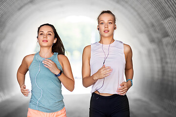 Image showing women or female friends with earphones running