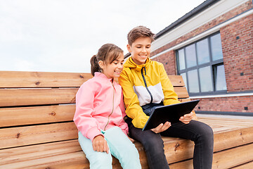 Image showing children with tablet computer sitting on bench