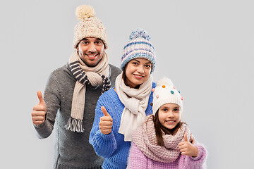 Image showing happy family in winter clothes on grey background