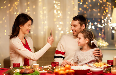 Image showing happy family taking picture at christmas dinner