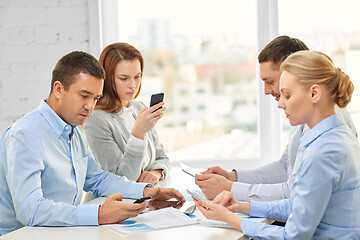 Image showing business team using smartphones at office