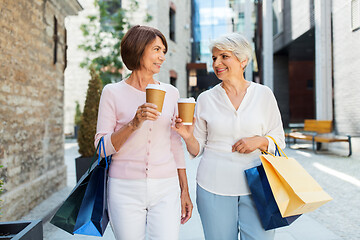 Image showing senior women with shopping bags and coffee in city