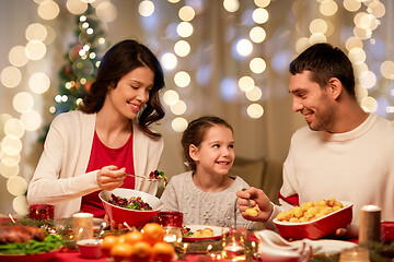 Image showing happy family having christmas dinner at home