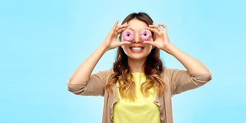 Image showing happy asian woman with eyes of donuts