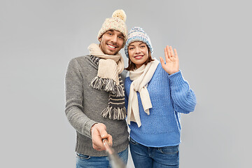 Image showing happy couple in winter clothes taking selfie