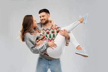 Image showing happy couple at christmas ugly sweater party