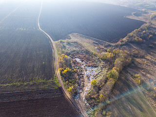 Image showing Aerial view from a drone above landfill site and plowed agricultural fields.