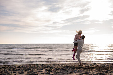 Image showing Loving young couple on a beach at autumn sunny day