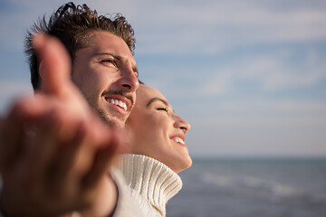 Image showing Loving young couple on a beach at autumn sunny day