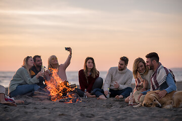 Image showing Friends having fun at beach on autumn day