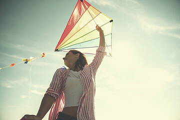 Image showing Young Woman with kite at beach on autumn day