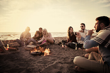 Image showing Friends having fun at beach on autumn day