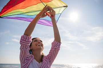 Image showing Young Woman with kite at beach on autumn day