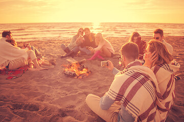 Image showing Friends having fun at beach on autumn day