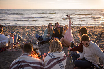 Image showing Friends having fun at beach on autumn day