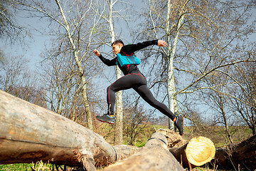 Image showing Man running in a park or forest against trees background.