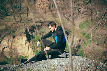 Image showing Man after running in a park or forest against trees background.