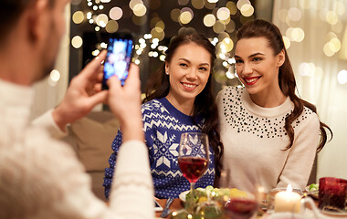 Image showing friends having christmas dinner and taking picture