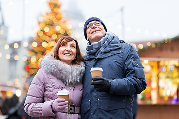 Image showing senior couple with coffee at christmas market