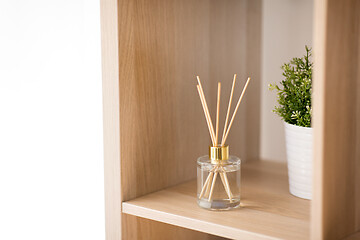 Image showing aroma reed diffuser on wooden shelf