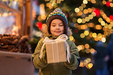 Image showing happy boy with gift box at christmas market