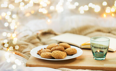 Image showing oatmeal cookies and candle in holder at home