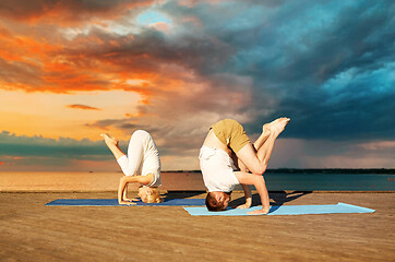 Image showing couple making yoga outdoors