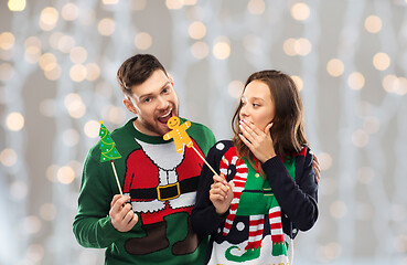 Image showing couple with christmas party props in ugly sweaters