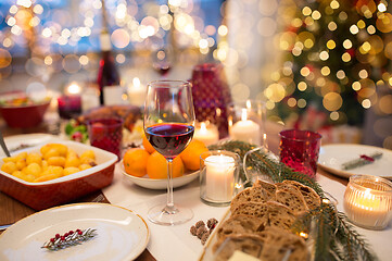 Image showing glass of red wine and food on christmas table