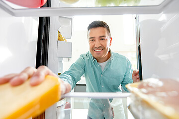 Image showing man taking food from fridge at kitchen