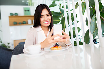 Image showing asian woman with smartphone at cafe or coffee shop