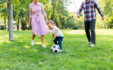 Image showing happy family playing soccer at summer park