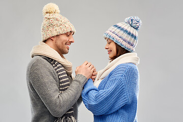 Image showing happy couple in winter clothes holding hands