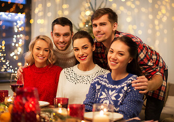 Image showing happy friends celebrating christmas at home