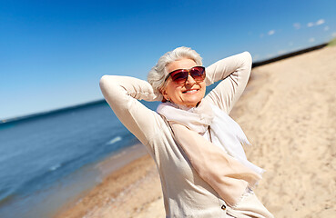 Image showing portrait of senior woman in sunglasses on beach