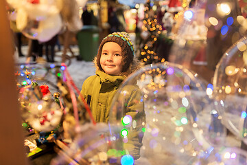 Image showing happy little boy at christmas market in winter