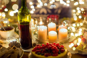 Image showing food, drinks and candles burning on table