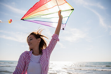 Image showing Young Woman with kite at beach on autumn day