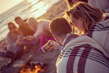 Image showing Friends having fun at beach on autumn day