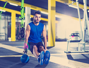 Image showing Young strong man doing pushups