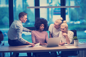 Image showing Multiethnic startup business team in night office