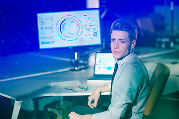 Image showing man working on computer in dark office